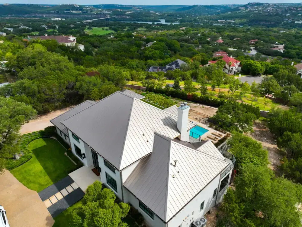 An overhead view of a large residential home in Texas with a metal roof installed by Texas Roof Repair.