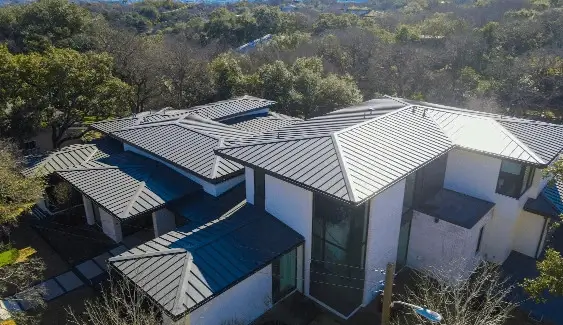 A large residential home with a new metal roof installed by Texas Roof Repair.