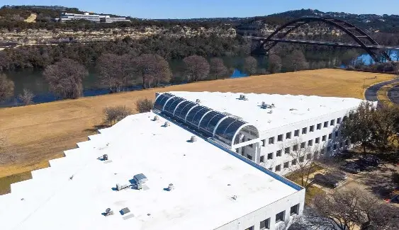 A large commercial building with a new roof installed by Texas Roof Repair.