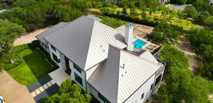 A aerial view of a home with a new metal roof installed by Texas Roof Repair.