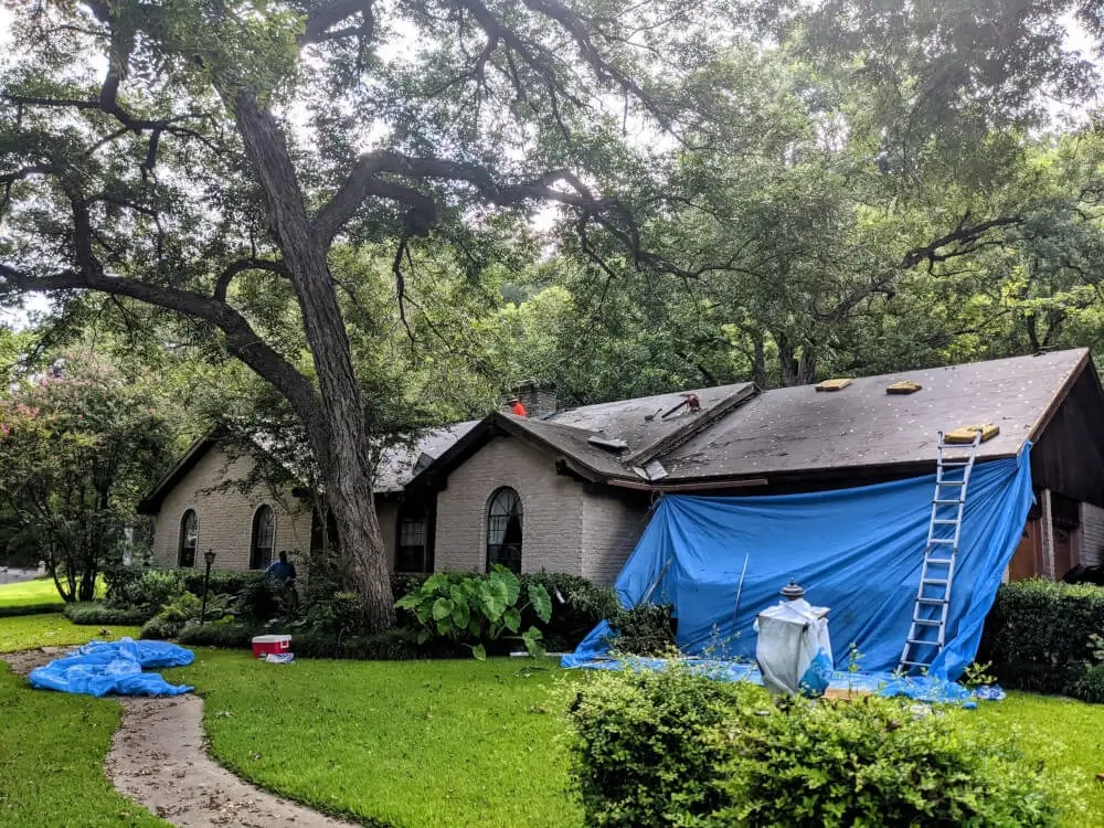 A Texas Roof Repair crew at work installing shingles on a residential home in Texas.